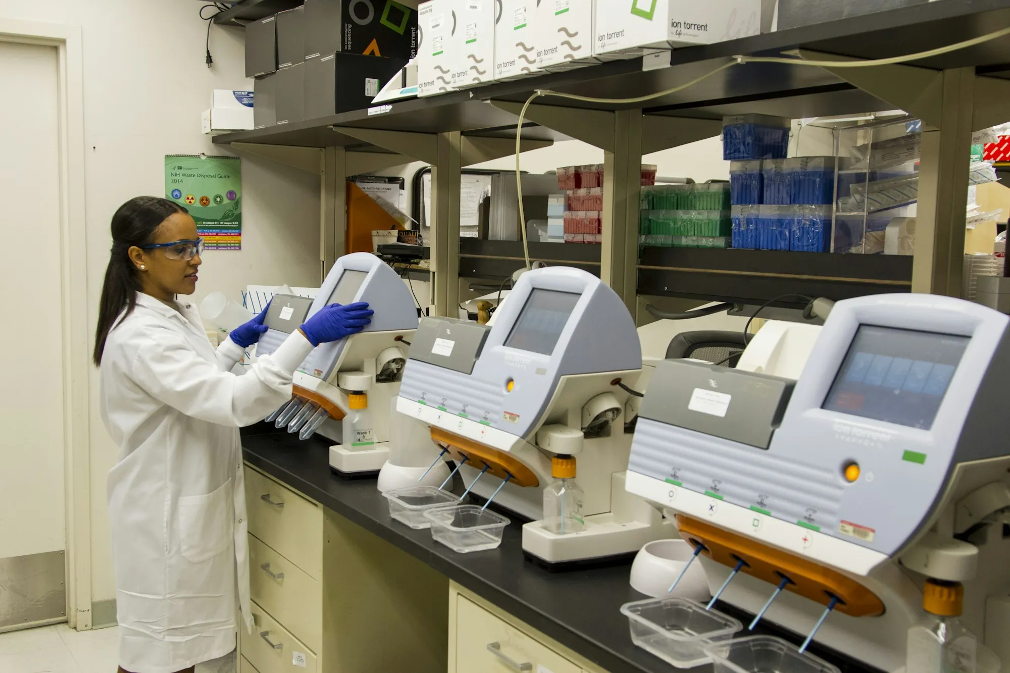 Lab technician running sample analysis equipment